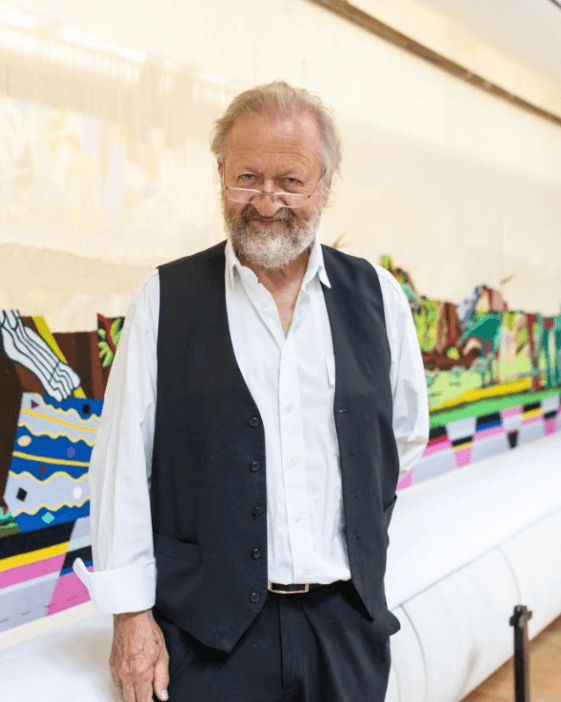 Bjørn Nørgaard in his studio before a tapestry